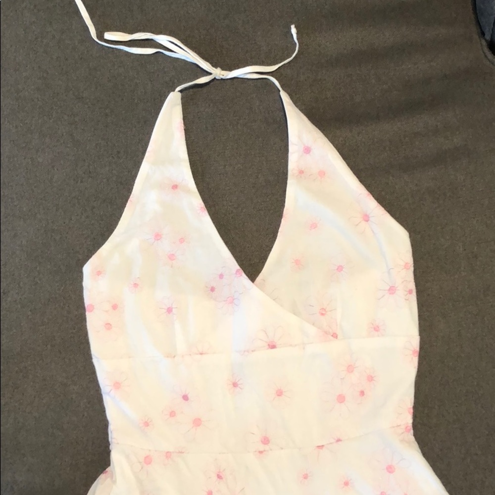 White dress with embroidered light pink flowers.